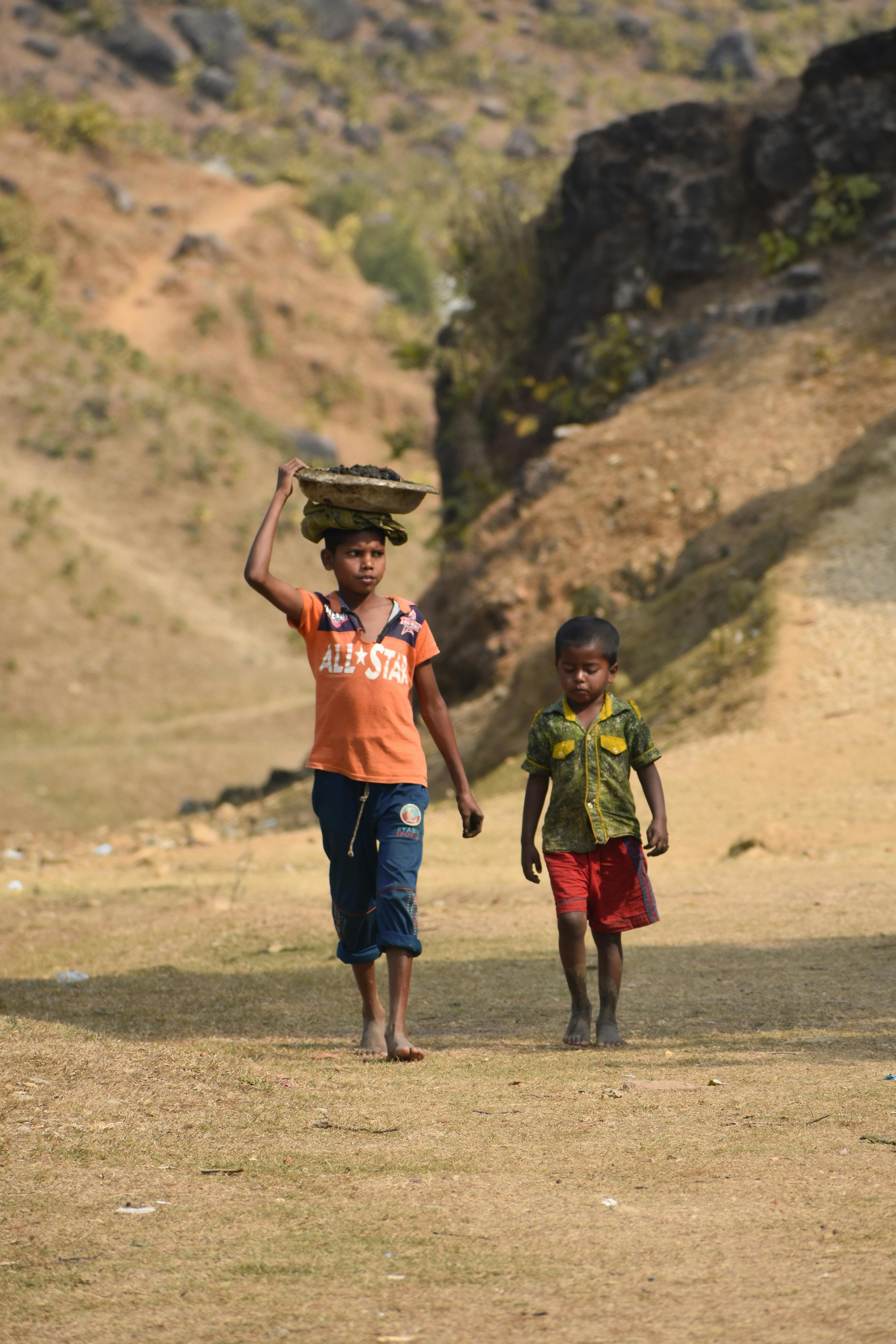 boy carrying a basket on his head