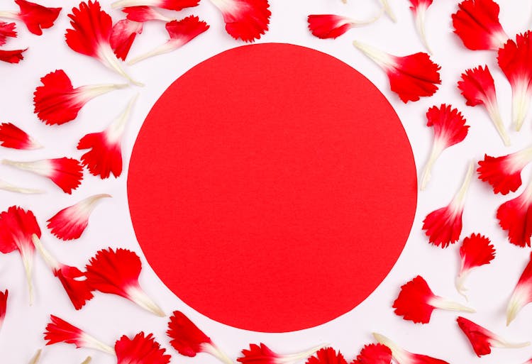 Red Circle With Flower Petals Around 