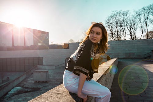 Woman in Black Top and White Pants