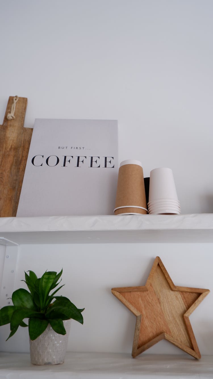 Shelf With Flower Vase And Disposable Paper Cups