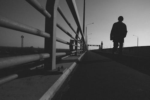 Person Walking on a Bridge