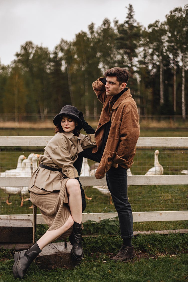 Woman Sitting On Chair And Man Standing By