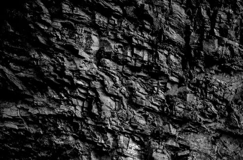 Free Grayscale close-up of a rocky surface showcasing intricate texture and pattern. Stock Photo