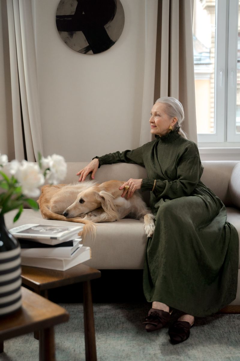 Senior woman sitting on a couch with her dog