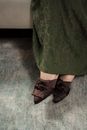 Unrecognizable Female Feet in Brown Velvet Mules