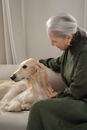 Senior Lady Enjoying Staying with her Dog at Home
