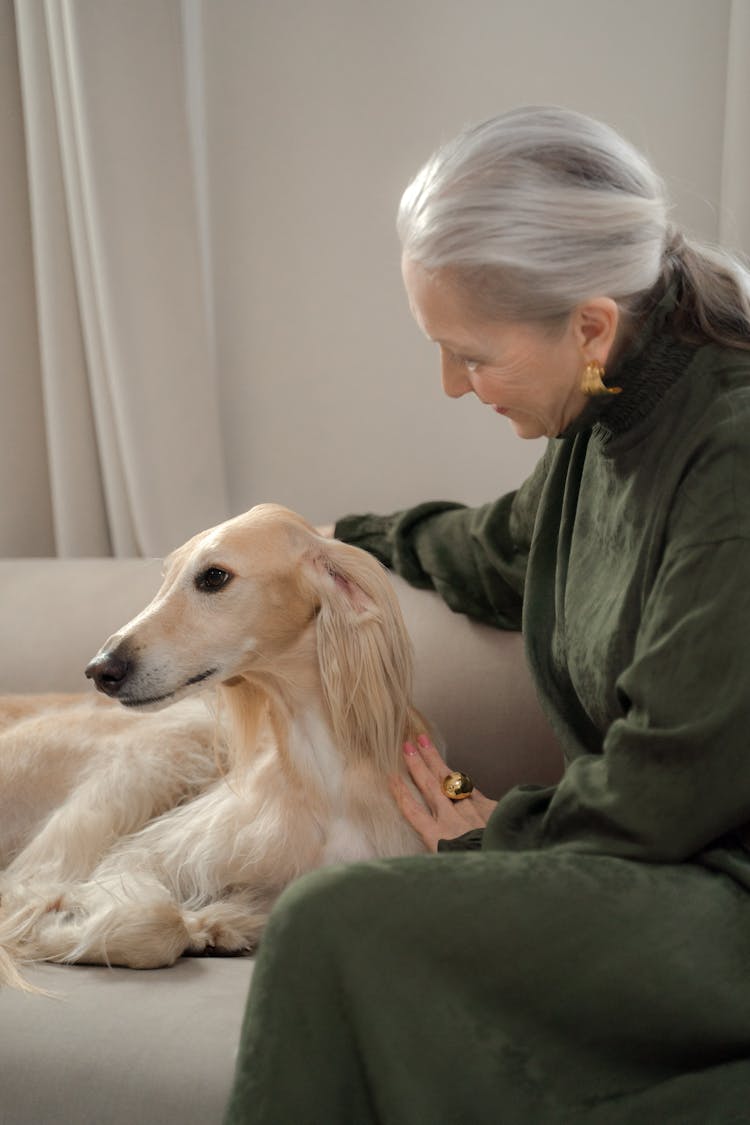 Senior Lady Enjoying Staying With Her Dog At Home