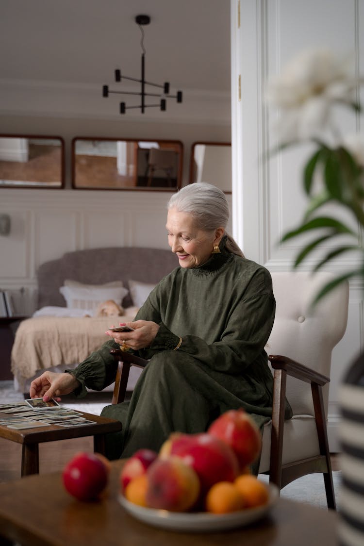 Senior Woman Playing Solitaire In Her Bedroom