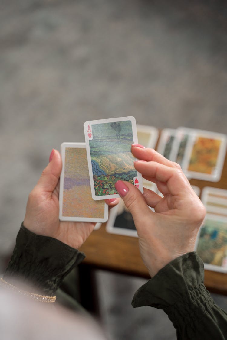 Female Hands Holding Cards