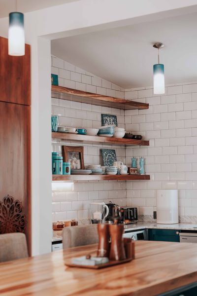 Kitchen with open timber shelving, photo by Keegan Checks on Pexels