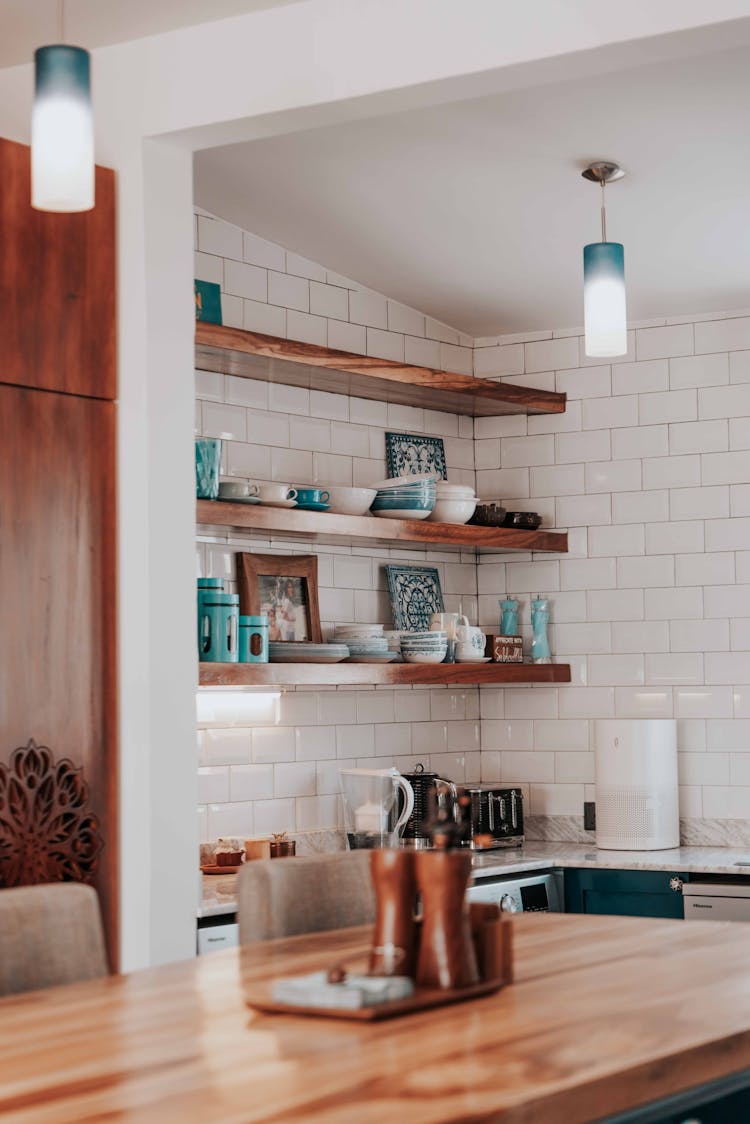 Plates And Bowls On Shelves In A Kitchen