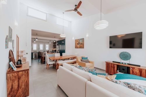 Free Modern and airy open-plan living room and dining area with stylish decor. Stock Photo