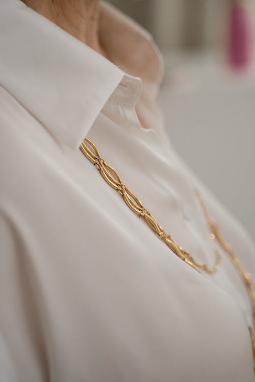 Gold necklase and the Elegant Shirt on the Elderly Woman