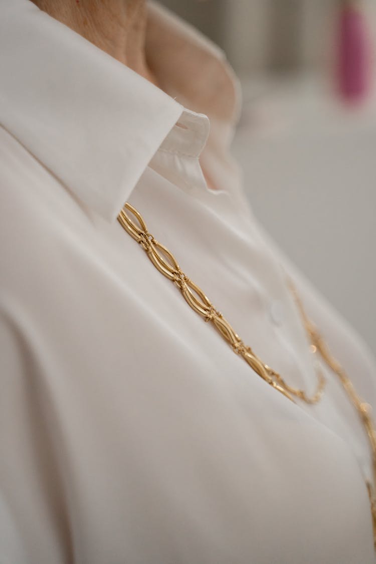 Gold Necklase And The Elegant Shirt On The Elderly Woman