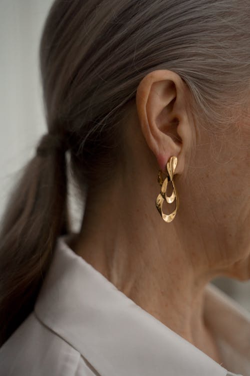 Elderly Woman Wearing Gold Earring