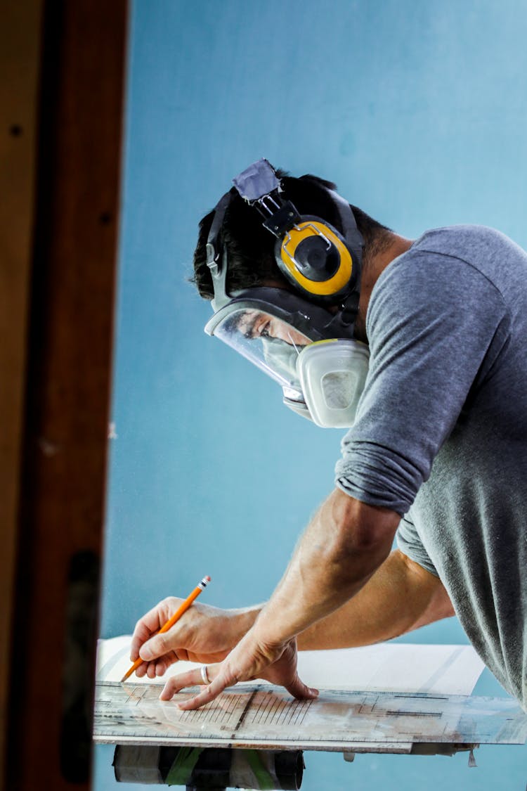 Man Wearing A Protective Mask Working On A Project 