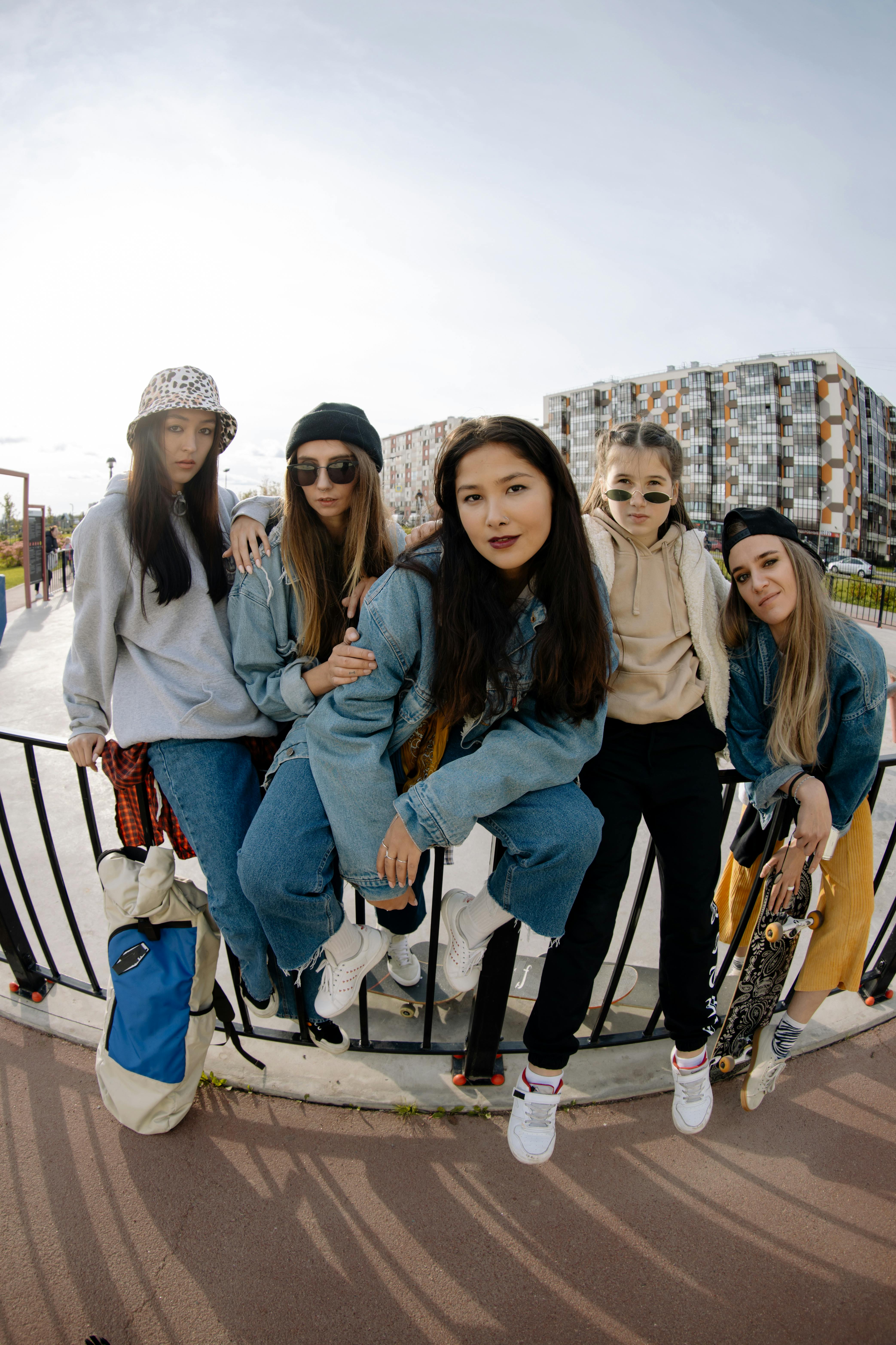 group of teenage girls sitting and leaning on metal railing