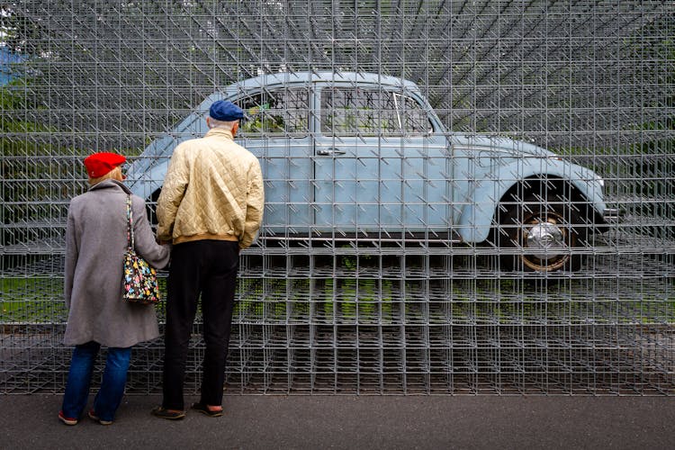 Elderly Couple Watching Classic Car