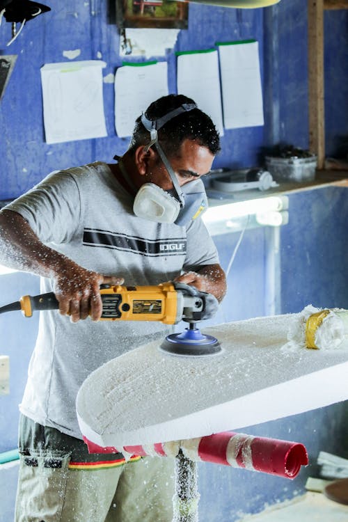 Free A Man Sanding the Wood Surface Stock Photo