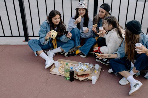 Group of People Sitting on the Concrete Floor