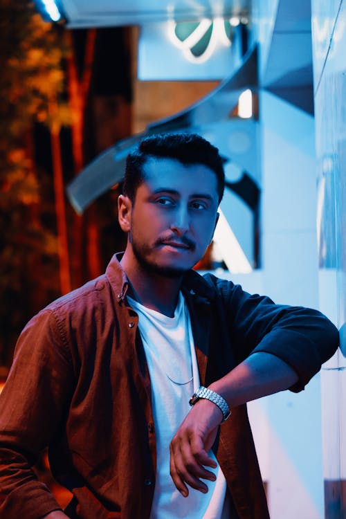 A Man in Brown Long Sleeves Wearing a Silver Wristwatch