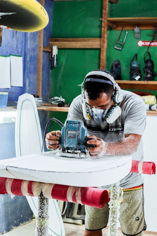 Man Using a Grinder in a Workshop 