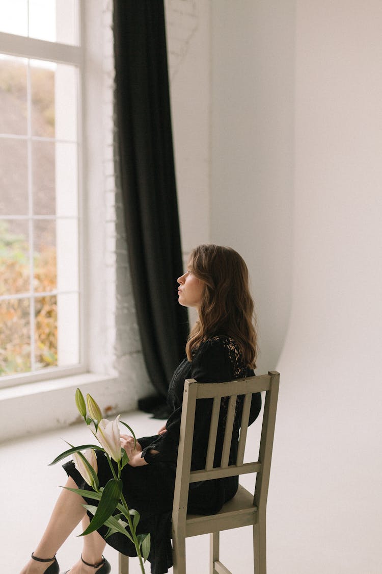 Woman Looking Through Window