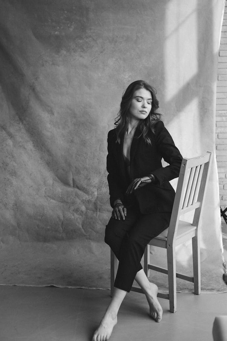 Beautiful Woman Sitting On Wooden Chair