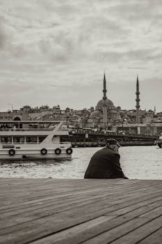 A serene view of the Istanbul skyline, showcasing the iconic Suleymaniye Mosque and waterfront.