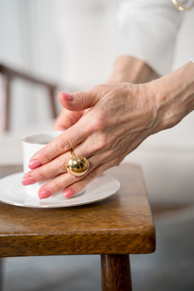 Hand Of Elderly Woman With Gold Ring