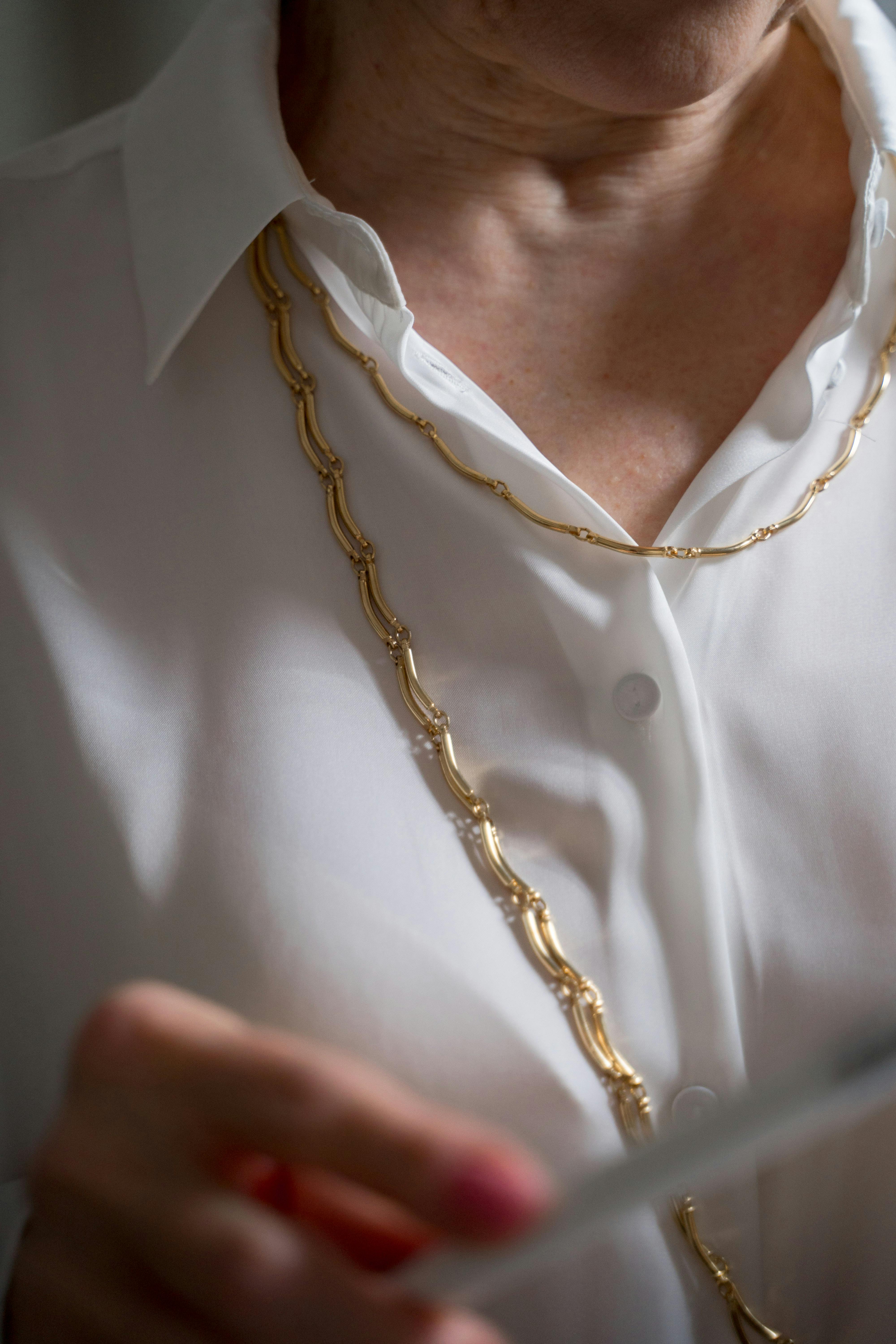 elderly woman in gold chain necklace