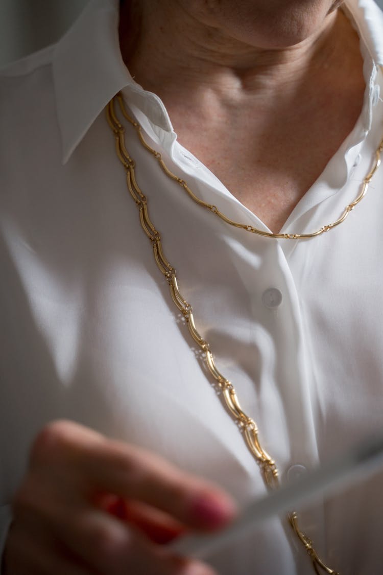 Elderly Woman In Gold Chain Necklace