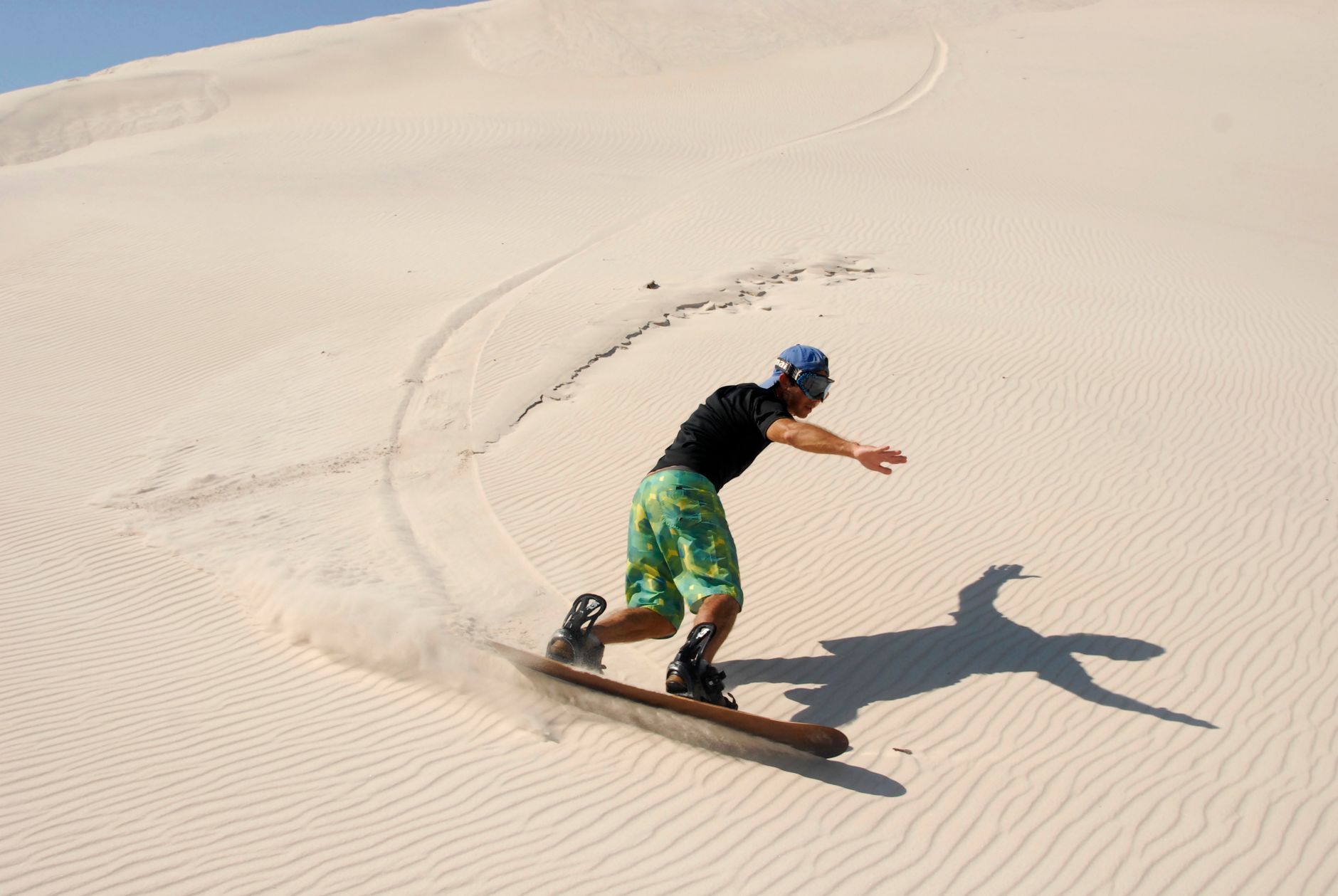 Sandboarding down the dunes of Paoay at sunrise when the sand is still cool