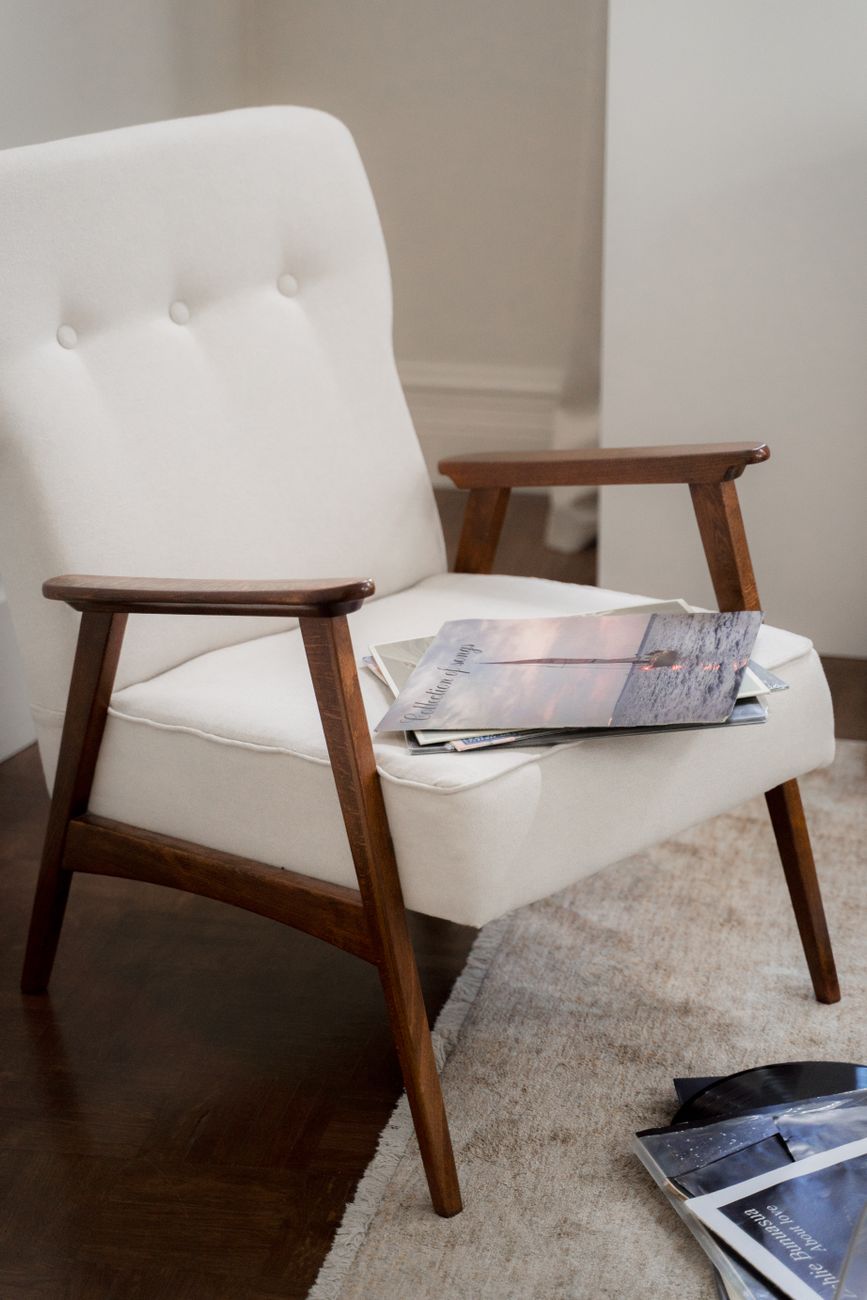 Elegant mid-century modern armchair with magazines on a plush carpet in a warm living room setting.. pexels, elegant, century