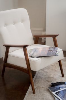 Elegant mid-century modern armchair with magazines on a plush carpet in a warm living room setting.. pexels, elegant, century