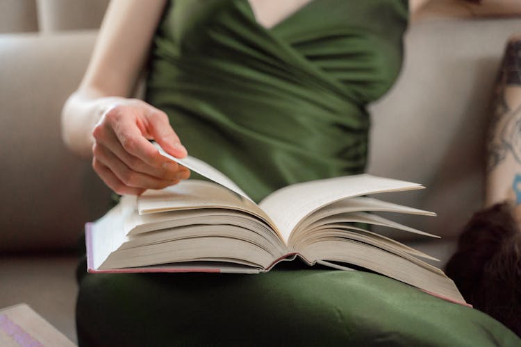 Close Up On Book In Womans Hand