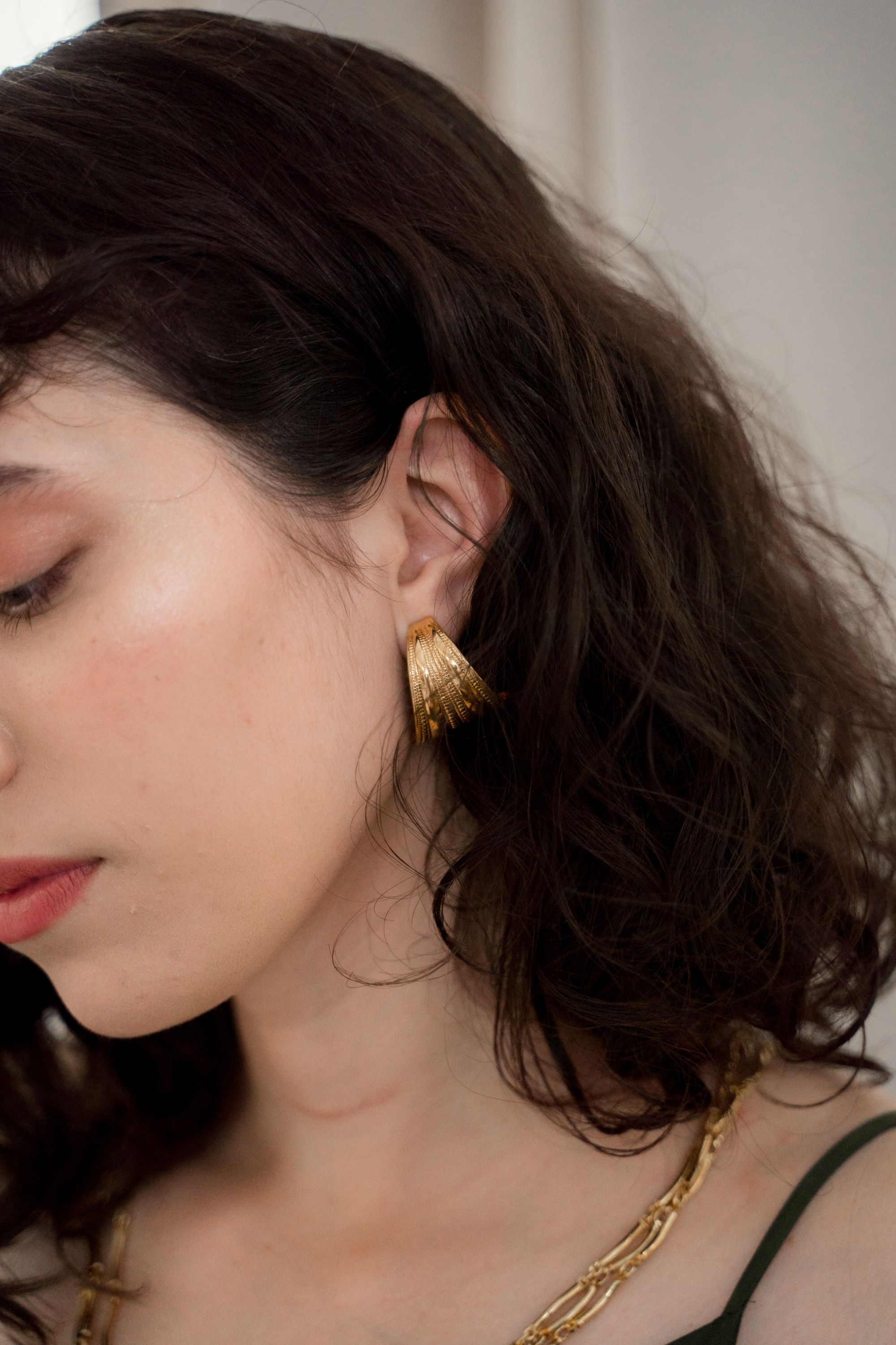 Woman wearing a sculpted gold earring