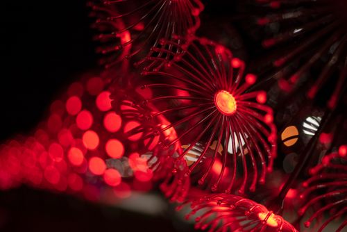 Free Close-up of a red light sculpture with a stunning bokeh effect, creating a vibrant abstract pattern. Stock Photo