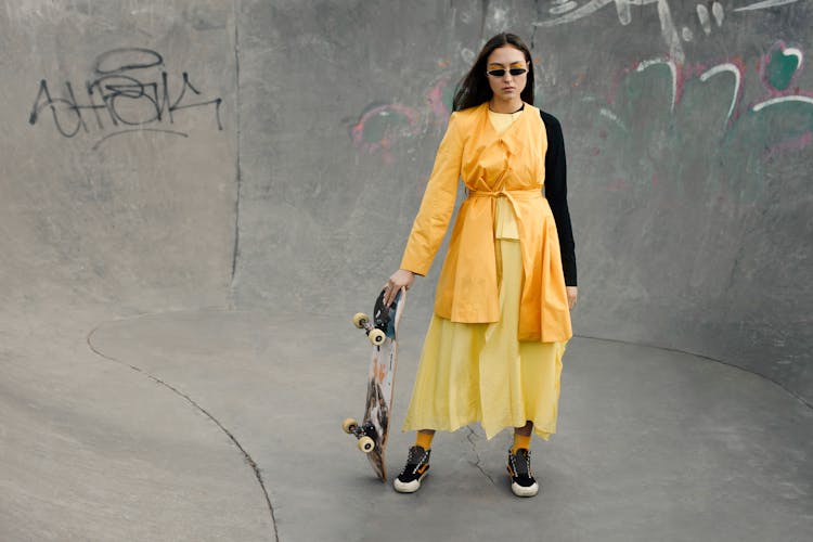 Stylish Woman Holding A Skateboard