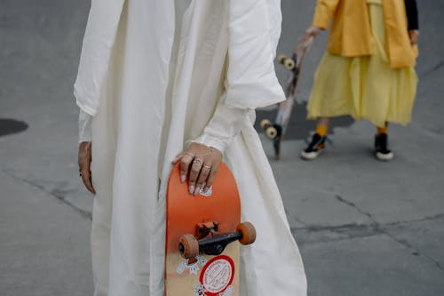 Close-up Shot of People Holding Skateboards