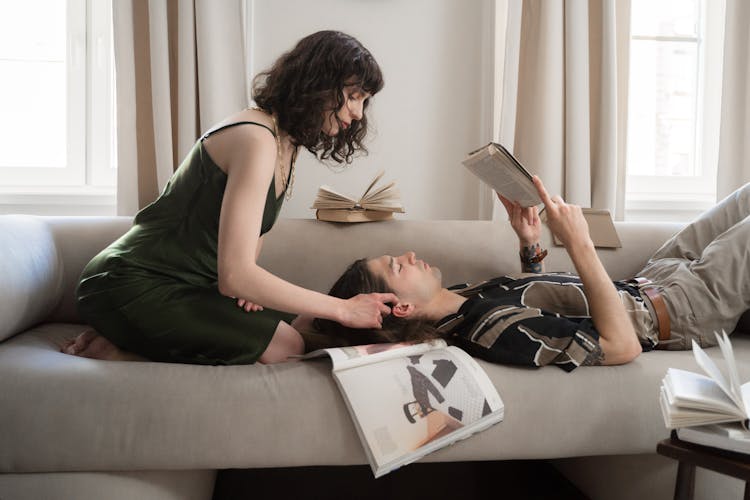 Woman Sitting On Bed And Touching Mans Hair