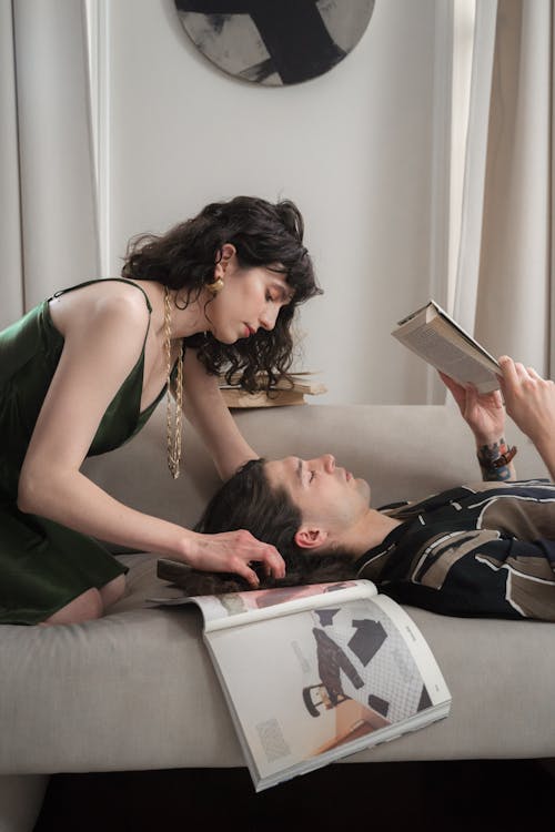 Woman Touching Mans Hair when Man Reads Book