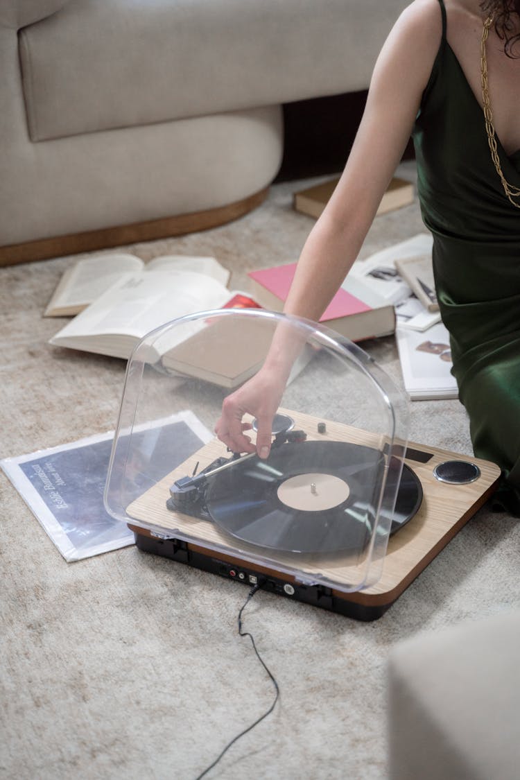 Woman Using Vinyl Recorder On Floor