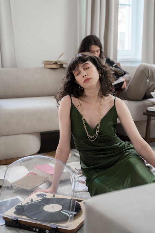 Woman Listening to Music from Vinyl Recorder with Closed Eyes