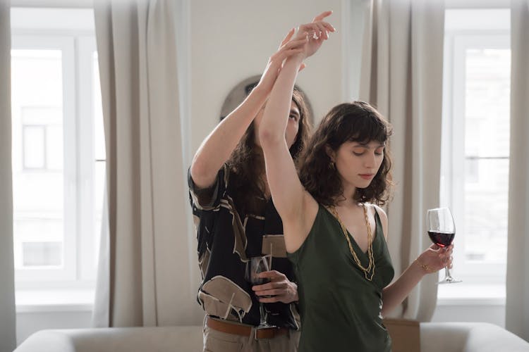 Man Holding Womans Arm With Wine Glass