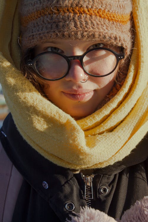A Woman in Black Framed Eyeglasses and Yellow Scarf