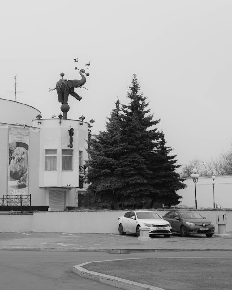 Black And White Shot Of Cars Parked In Front Of The Grandpa Durovs Corner Theatre, Moscow, Russia