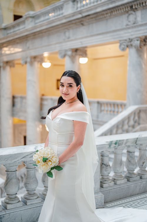 Free Beautiful bride in a classic wedding dress in a grand marble interior. Stock Photo