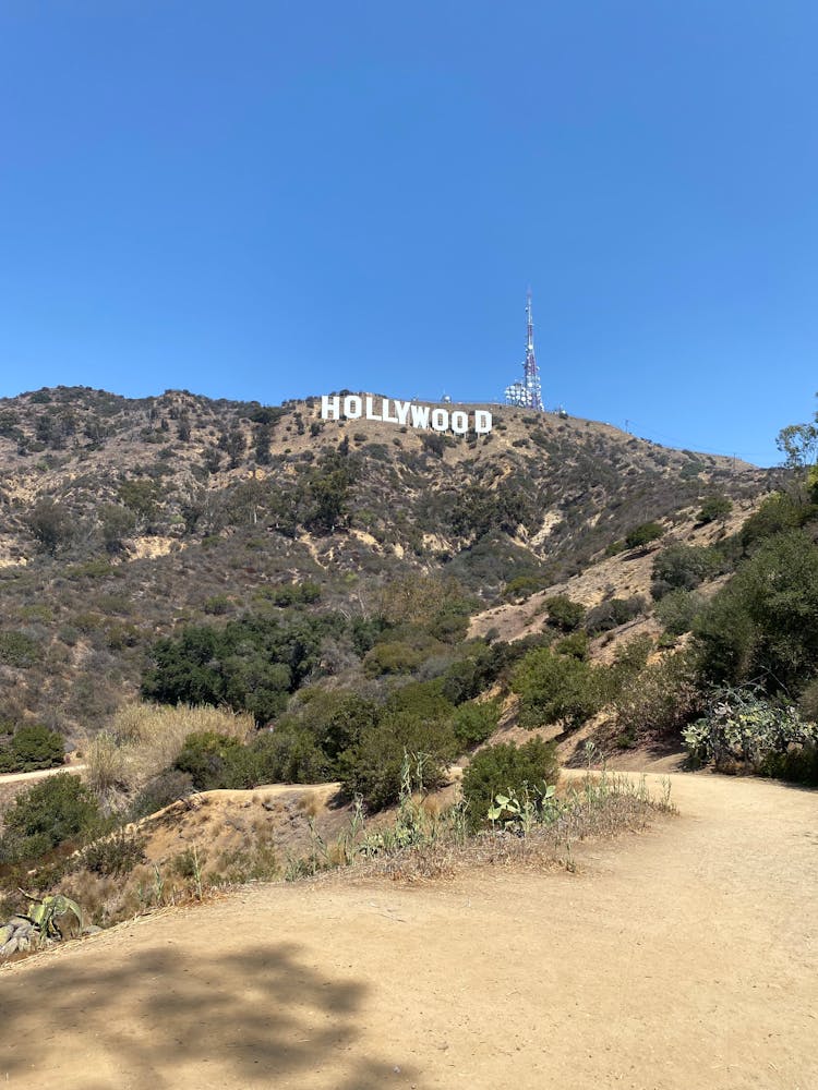 A Hollywood Sign On Mountain Under The Blue Sky