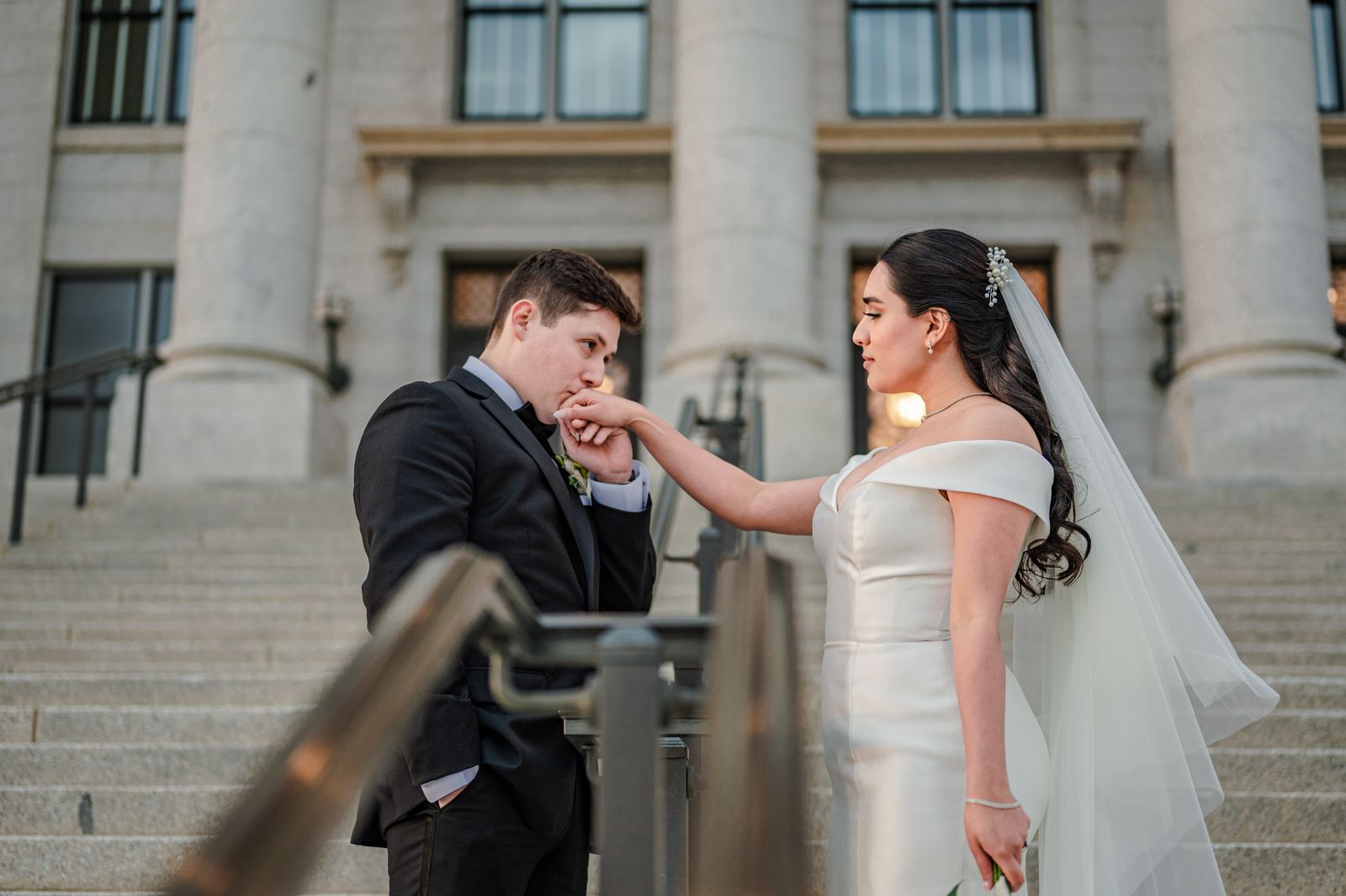 Newlyweds photographed together on courthouse steps after their wedding